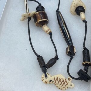 Ethnic hand carved wood black cord necklace.